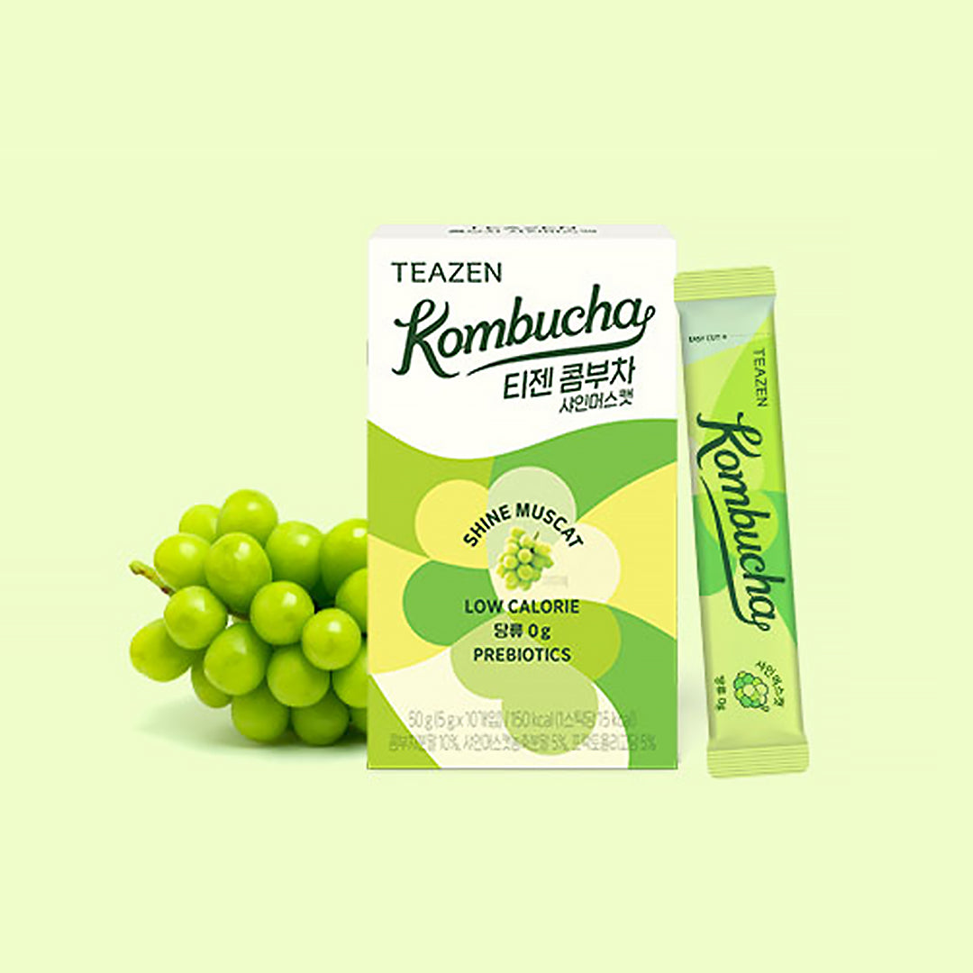 Teazen Kombucha package with a stick pack and grapes on a light green background