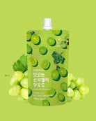 A green stand-up pouch of sugarlab0 grape-flavored drink powder with a white cap, surrounded by illustrated and photographic green grapes and leaves on a light green background.