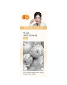 A vertical skincare product package or card on a white background, featuring Korean text, orange fruit illustrations, a portrait of a woman at the top, and a grayscale photo of pumpkins near the bottom.