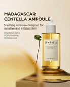 A bottle of SKIN1004 Madagascar Centella Ampoule with a white dropper cap, filled with golden-yellow serum, displayed on a pedestal with a blurred leaf prop against a warm beige background with promotional text.
