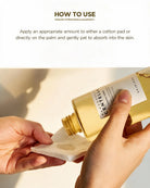 A close-up of hands holding a gold cosmetic bottle and patting a cotton pad, with text above reading 'HOW TO USE' and instructions on applying the product.