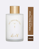 A frosted glass bottle of KoY Volume Base Toner with a metallic gold cap, shown next to a vertical brown label indicating 'Volume Base Toner' and '100ml'.