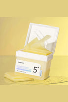 Cosmetic product with a white lid on a yellow background