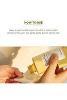 Gold bottle being used to apply a product on a cotton pad with text on how to use.