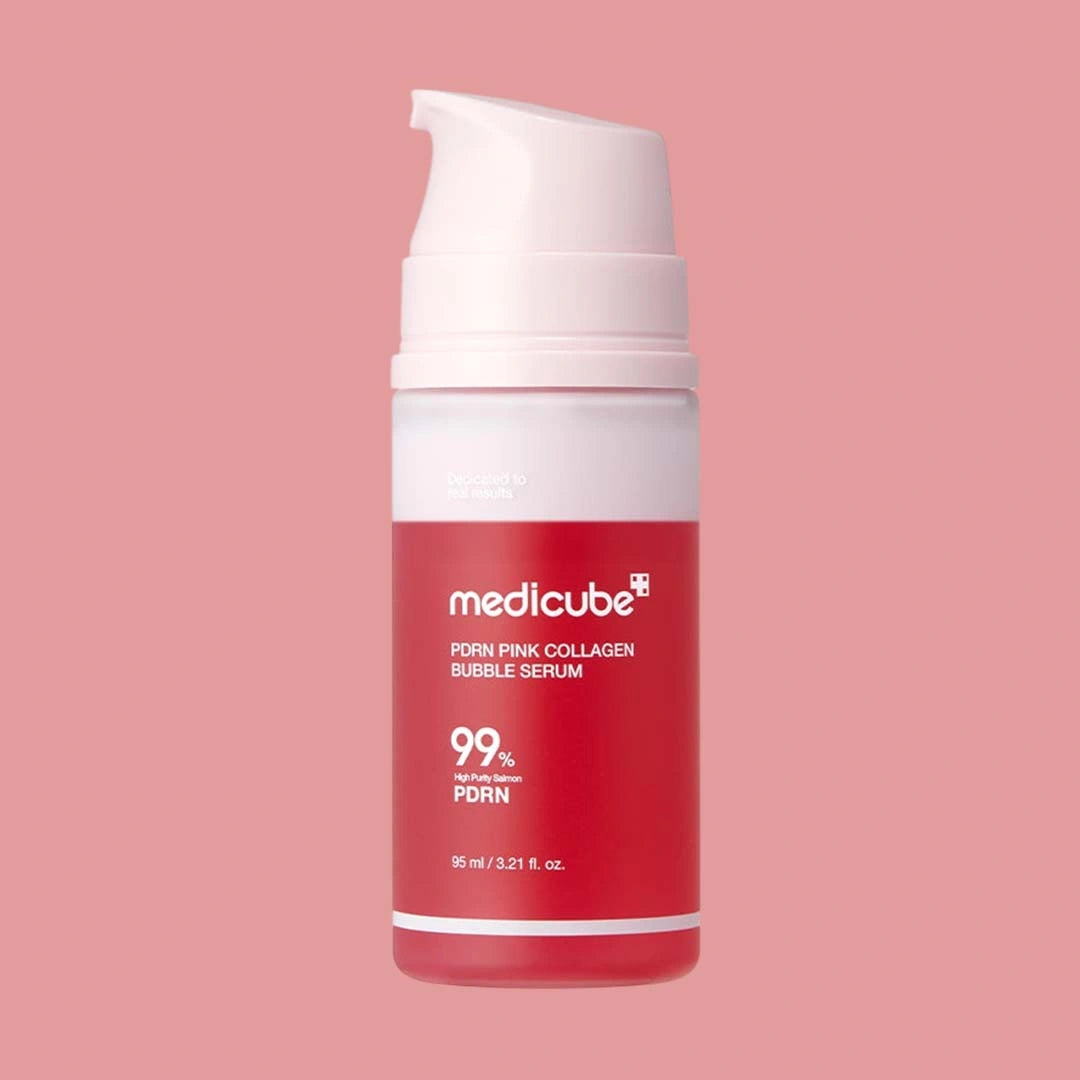 Red skincare serum bottle with white pump on a pink background