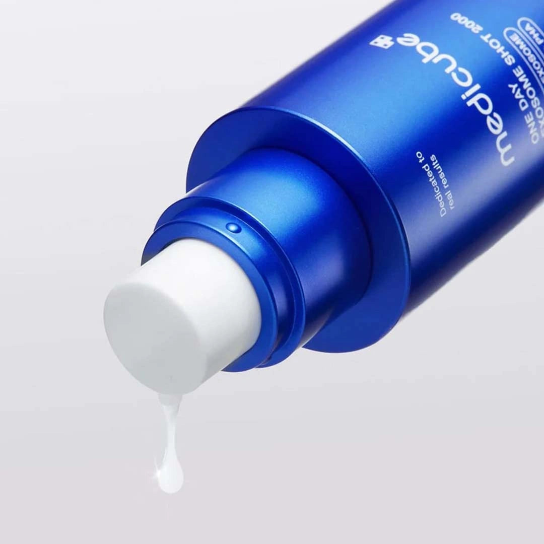 Blue bottle of Mediclean with white cream being squeezed out on a light gray background