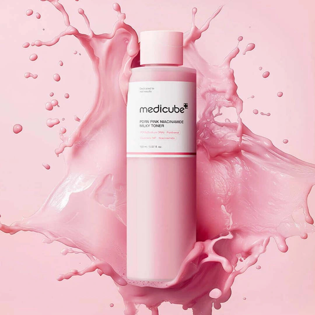 Medicube pink bottle with pink liquid splashes on a pink background