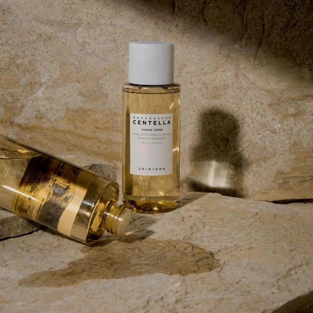 Two bottles of Skintox Cretella on a stone surface with a neutral background