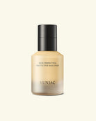 Yunjac Skin Perfecting Protective Base Prep bottle with a black cap and beige-toned liquid visible through the frosted bottle, centered on a light cream background.