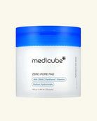 A white jar of Medicube Zero Pore Pad with a bright blue screw-on lid, centered on a light cream background.